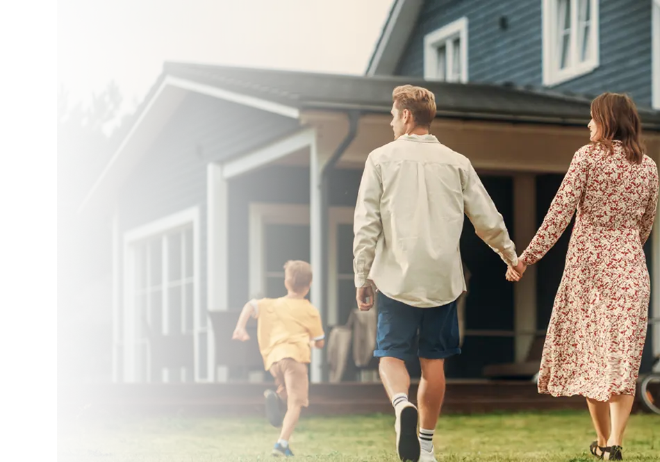 A family walks toward their suburban home, reflecting the home insurance protection